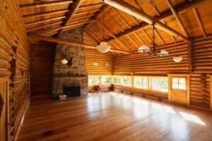 Open room with wood flooring for activities at Feathered Pipe Ranch in Montana.