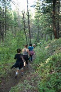 Women hiking on a trail at Feathered Pipe Ranch in Montana.