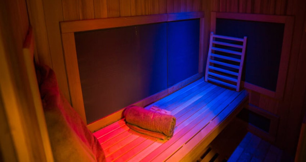 A view of an infrared sauna from the inside showing a bench to sit and were the heat lamps shine.