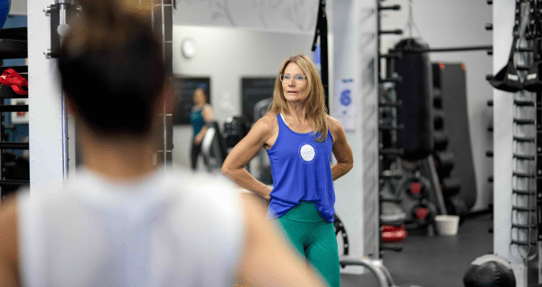 Shannon Hamlin, group fitness instructor, teaching a class on the gym floor at the Well Studio