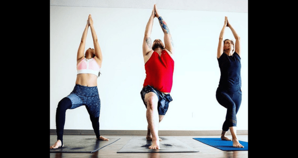 Students in a yoga pose, stretching and lengthening